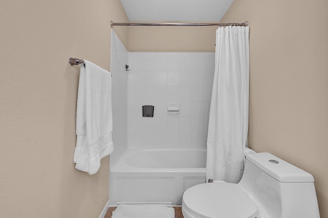 full bathroom featuring shower / tub combo and toilet