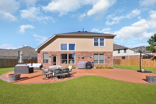 rear view of property with brick siding, fence, a lawn, an outdoor hangout area, and a patio area