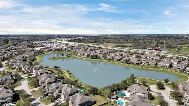 drone / aerial view featuring a residential view and a water view