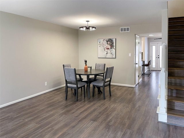 dining room with visible vents, baseboards, stairs, and dark wood-type flooring