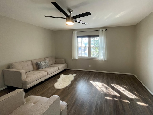 unfurnished living room with a ceiling fan, baseboards, and wood finished floors