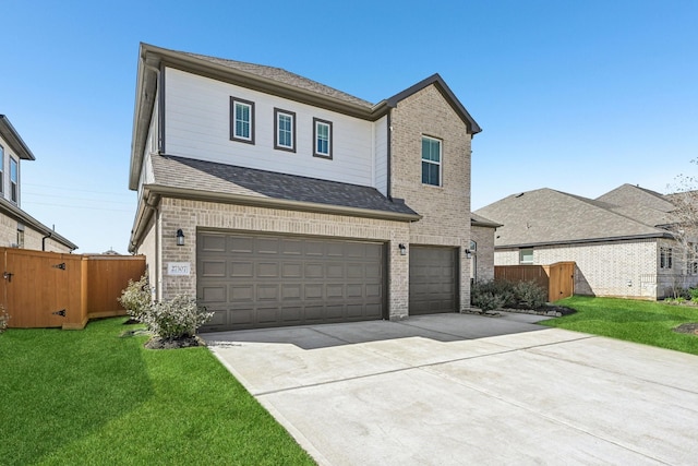 view of front facade with a front yard, brick siding, an attached garage, and fence