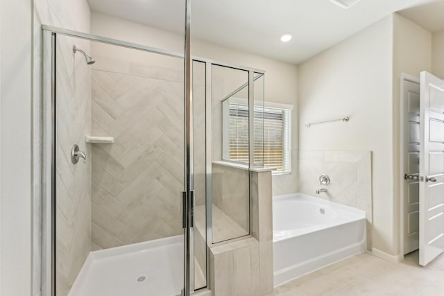 full bath with a bath, a shower stall, and tile patterned flooring