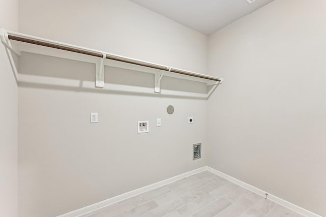 washroom featuring hookup for an electric dryer, washer hookup, baseboards, gas dryer hookup, and laundry area