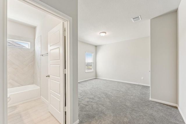 full bathroom with visible vents, baseboards, and toilet