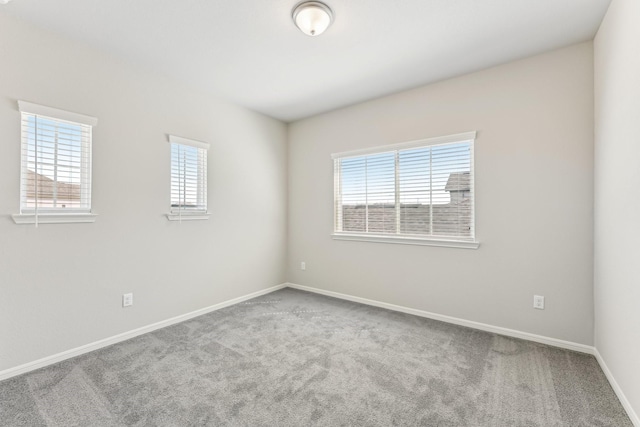 unfurnished room featuring baseboards and carpet floors