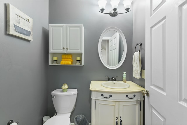 half bathroom with vanity and toilet