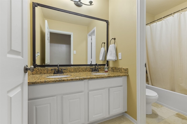 bathroom with double vanity, toilet, shower / bath combo, and a sink