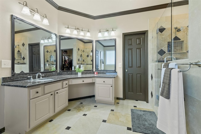 bathroom with a closet, vanity, a stall shower, and crown molding