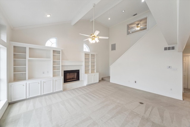 unfurnished living room featuring visible vents, light colored carpet, beamed ceiling, and a ceiling fan