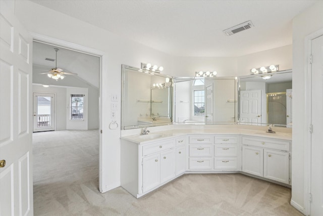 full bathroom with ceiling fan, double vanity, visible vents, and a sink