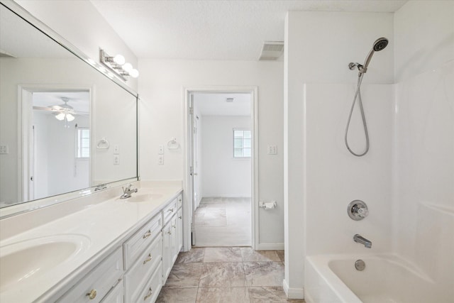 bathroom featuring double vanity, shower / tub combination, a ceiling fan, and a sink