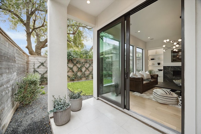 doorway featuring recessed lighting, built in shelves, a fireplace, and tile patterned flooring