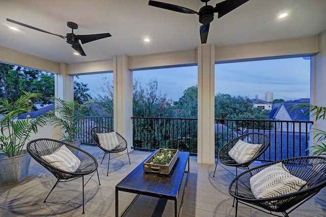 sunroom / solarium with a ceiling fan