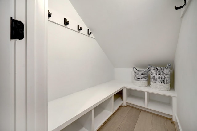 mudroom with light wood-style flooring and vaulted ceiling