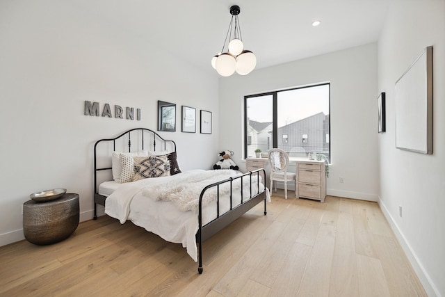 bedroom featuring a notable chandelier, recessed lighting, baseboards, and light wood finished floors