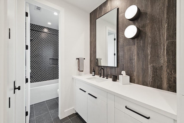 full bath featuring tile patterned floors, visible vents, toilet, shower / washtub combination, and vanity