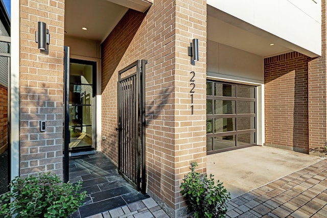 entrance to property featuring brick siding