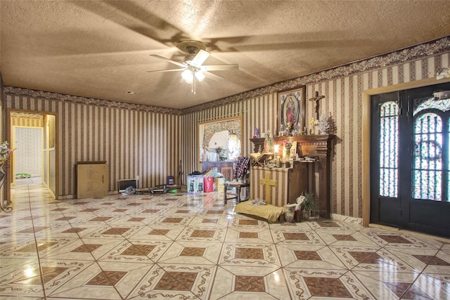 interior space with wallpapered walls, light tile patterned floors, and a textured ceiling