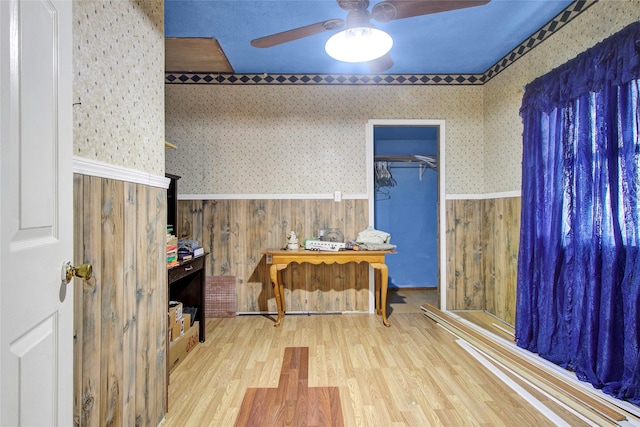 office with ceiling fan, wood finished floors, wainscoting, and wallpapered walls