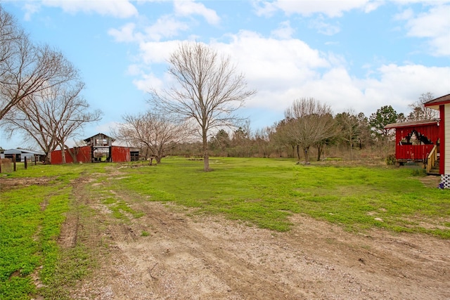 view of yard with a barn and an outdoor structure