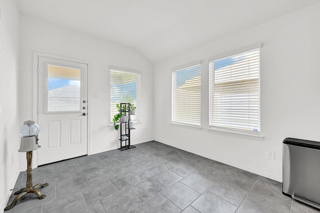 entryway with lofted ceiling and baseboards