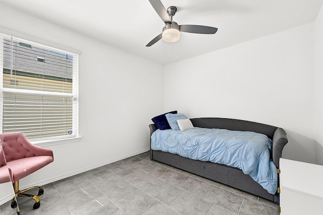 bedroom featuring baseboards and ceiling fan