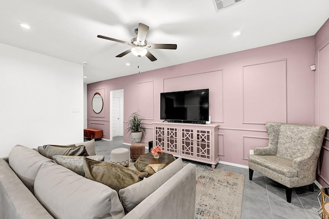 living room with light tile patterned floors, a ceiling fan, visible vents, recessed lighting, and a decorative wall