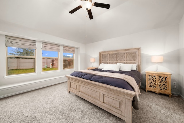 bedroom featuring vaulted ceiling, carpet flooring, baseboards, and ceiling fan