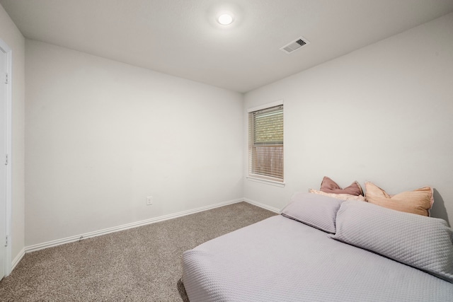 bedroom featuring visible vents, carpet floors, and baseboards