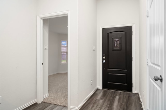 entrance foyer with dark wood-style floors and baseboards