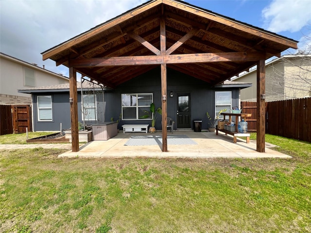 back of house with a patio area, a yard, and fence