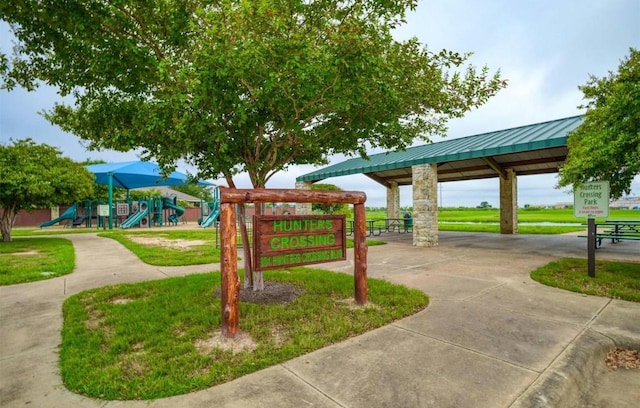 view of property's community featuring a gazebo, a lawn, and playground community