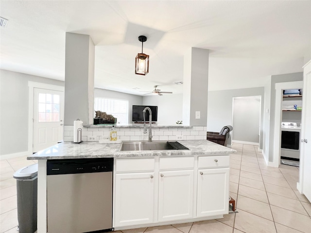 kitchen featuring a sink, light stone counters, white cabinetry, washer / dryer, and dishwasher