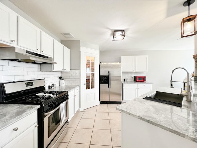 kitchen featuring light tile patterned floors, a sink, under cabinet range hood, appliances with stainless steel finishes, and white cabinetry