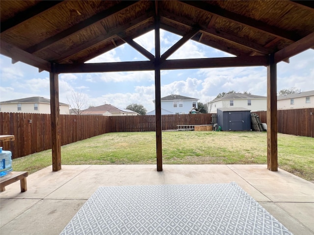 view of patio / terrace with an outbuilding, a gazebo, a storage shed, and a fenced backyard