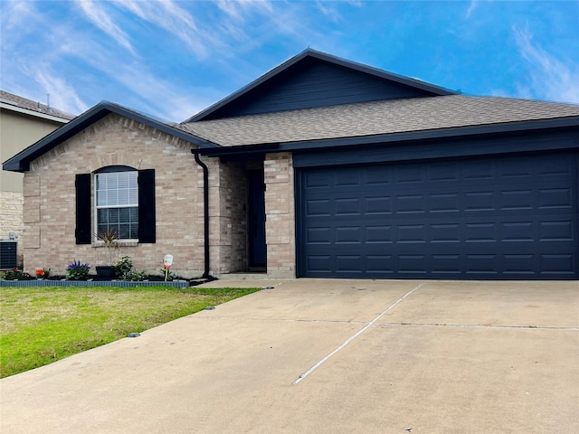 ranch-style home with brick siding, a shingled roof, a front lawn, cooling unit, and driveway