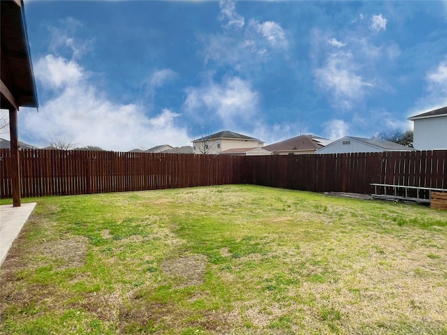 view of yard with a fenced backyard