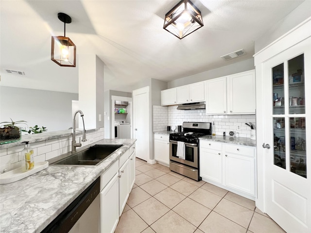 kitchen featuring under cabinet range hood, visible vents, appliances with stainless steel finishes, and a sink