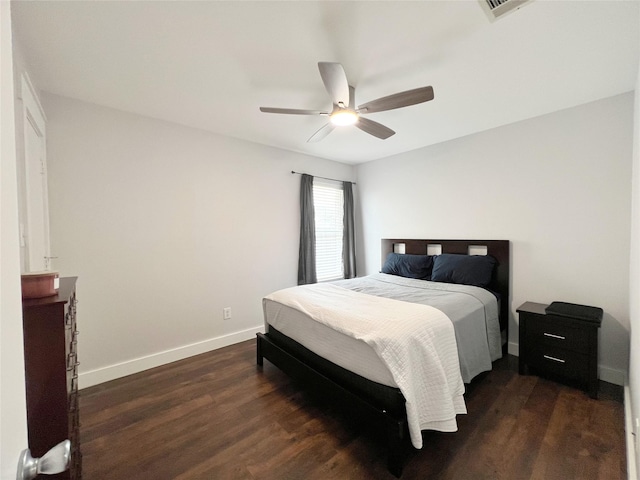 bedroom featuring dark wood finished floors, visible vents, a ceiling fan, and baseboards