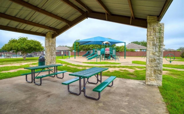 community jungle gym with a yard and fence