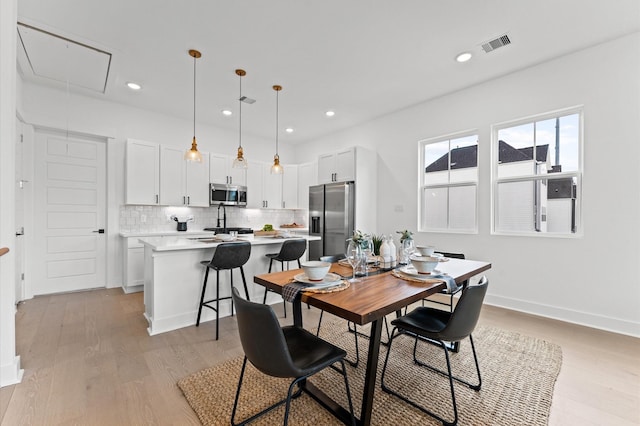 8305 Springwood Creek Ln, Houston, TX 77055 - dining space featuring attic access, light wood-style floors, and recessed lighting