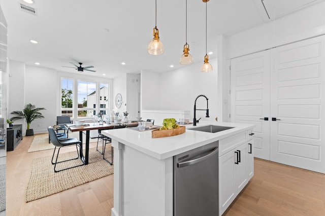 8305 Springwood Creek Ln, Houston, TX 77055 - kitchen featuring dishwasher, light wood-style floors, light countertops, white cabinetry, and a ceiling fan