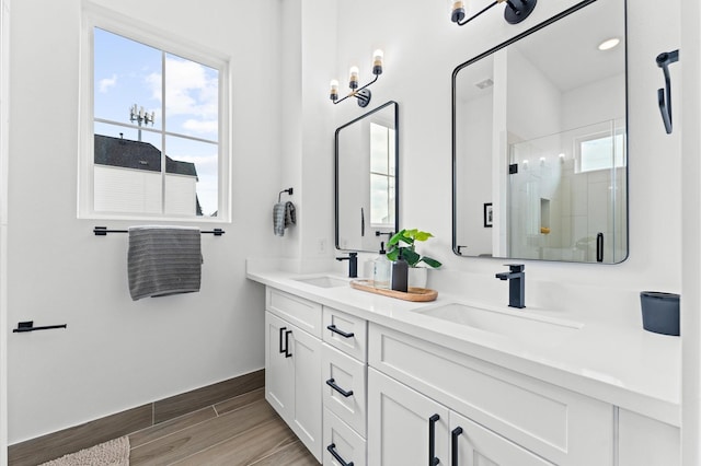 8305 Springwood Creek Ln, Houston, TX 77055 - full bathroom with double vanity, a stall shower, and wood finished floors