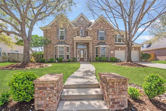 traditional-style home featuring a garage, driveway, brick siding, and a front lawn