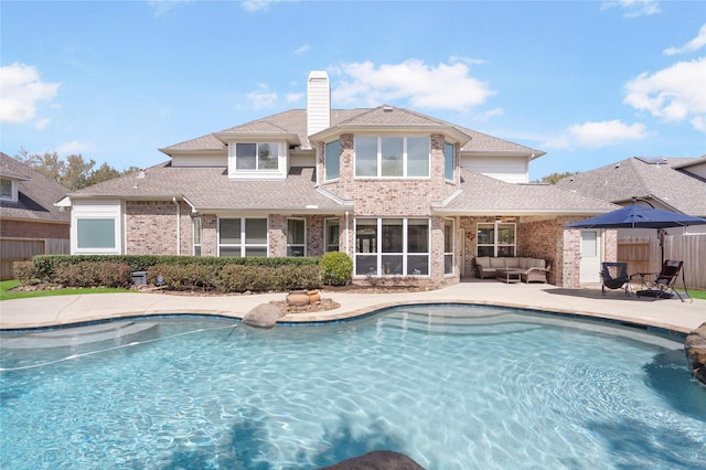 view of swimming pool featuring a patio area, a fenced in pool, outdoor lounge area, and fence