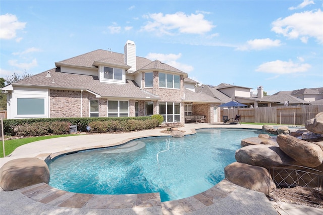 view of pool featuring a patio area, a fenced in pool, and fence