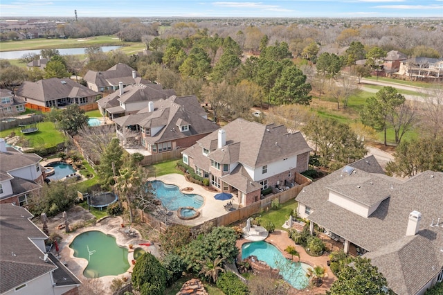 drone / aerial view with a residential view and a water view