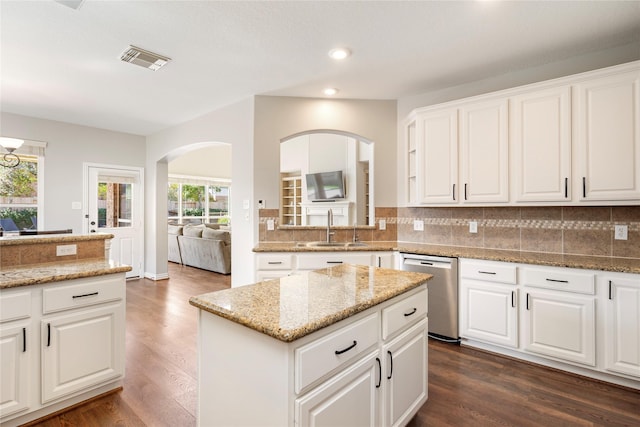 kitchen with a sink, visible vents, stainless steel dishwasher, and backsplash