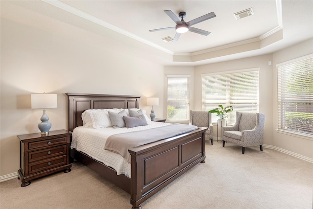 bedroom featuring visible vents, a raised ceiling, light colored carpet, and crown molding